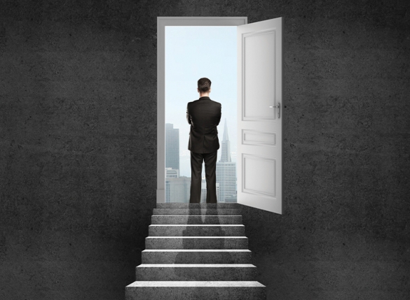 man looking through open door